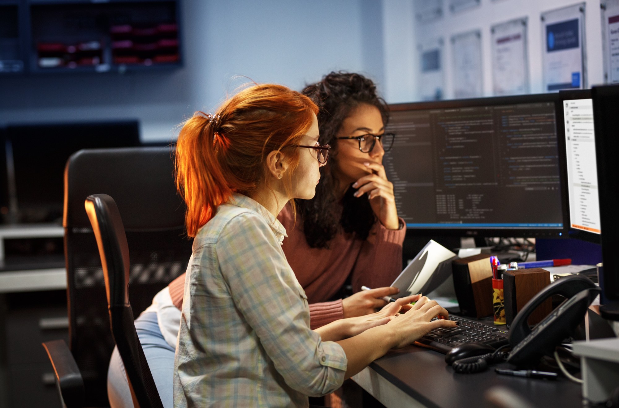 two women software developers working at a computer